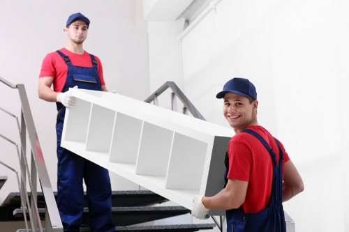 Man with van removal service loading furniture in Brent