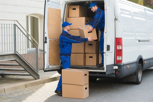 Professional movers carrying furniture during a Brent house removal