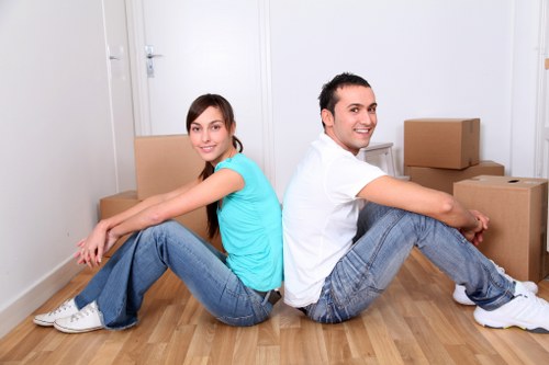 Household moving team handling furniture during a Brent home move